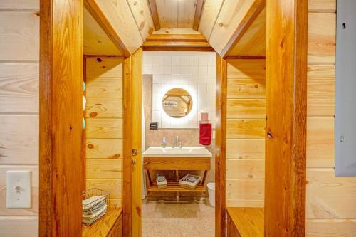 a bathroom with a sink in a wooden cabin at Greenbrier Beechhouse Luxury Treehouse in Greenbrier