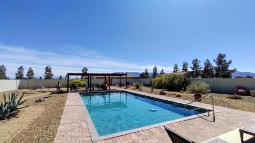 a swimming pool in the middle of a yard at Falcon Cottage in Pahrump