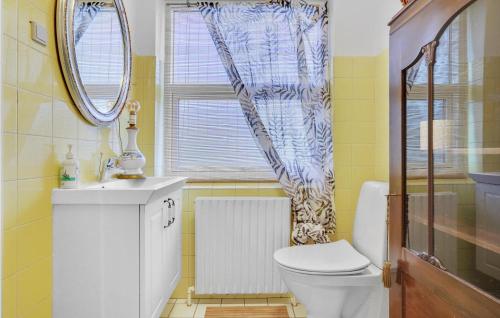 a bathroom with a toilet and a sink and a window at Holiday Home Slagelse With Sea View 09 in Lille Kongsmark