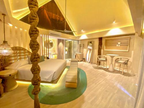 a bedroom with a large bed and a room with at Hotel Shibari - Restaurant & Cenote Club in Tulum