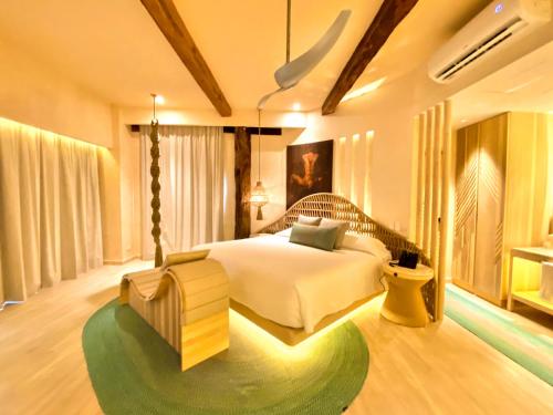 a bedroom with a bed and a green rug at Hotel Shibari - Restaurant & Cenote Club in Tulum