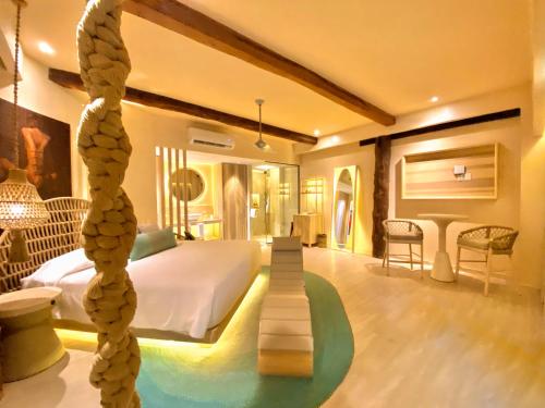 a hotel room with a bed and a tree in the middle at Hotel Shibari - Restaurant & Cenote Club in Tulum