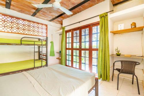 a bedroom with a bunk bed and a desk at Casa Tara in Taganga