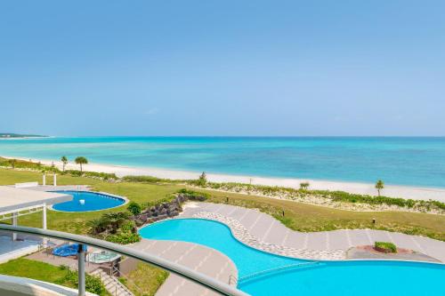 a view of the beach from the balcony of a resort at EN RESORT Kumejima EEF Beach Hotel in Kumejima