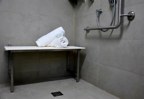 a roll of toilet paper sitting on a shelf in a bathroom at On Bell Glamping in Belford