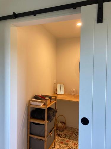 a small room with a desk and a shelf at Brighton Beach in Dunedin