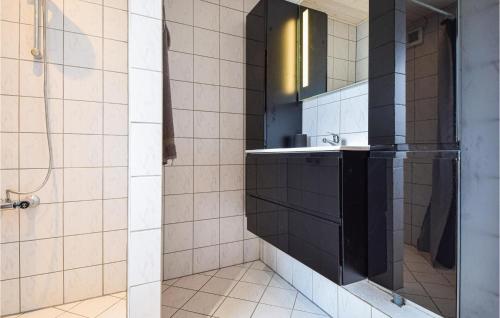 ein Bad mit einem Waschbecken und einem Spiegel in der Unterkunft 3 Bedroom Amazing Home In Otterup in Otterup