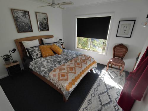 a bedroom with a bed and a window at Cape Colonnades alleyway in Cape Woolamai