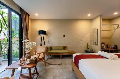 a bedroom with two beds and a living room at Nam An Mama Villa Hoi An in Hoi An