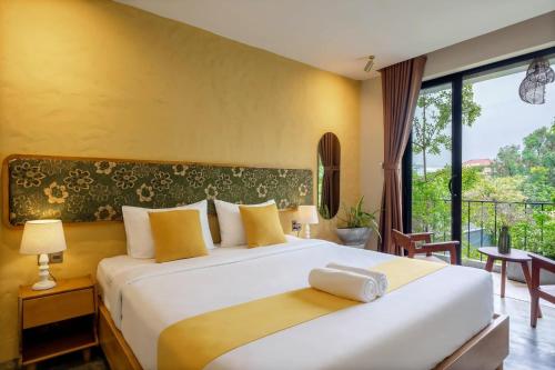 a bedroom with a large bed and a large window at Nam An Mama Villa Hoi An in Hoi An