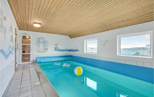 a swimming pool in a bathroom with a blue tub at Nice Home In Vejers Strand With Wifi in Vejers Strand