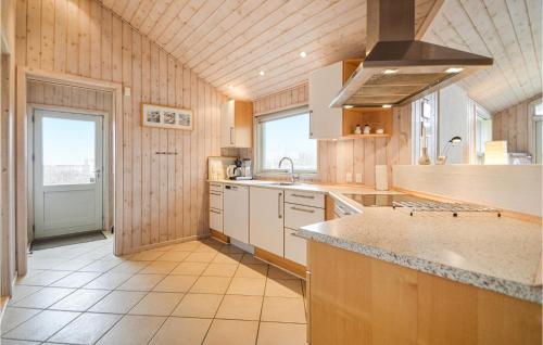 a large kitchen with a sink and a stove at Beautiful Home In Rm With 3 Bedrooms, Sauna And Wifi in Bolilmark
