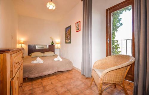 a bedroom with a bed and a chair and a window at Lovely Apartment In Carcheto Brustico With Outdoor Swimming Pool in Carcheto
