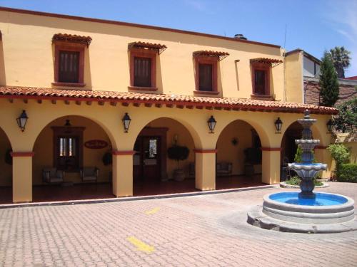 a building with a fountain in the middle of a courtyard at Mirador del Frayle in San Miguel de Allende