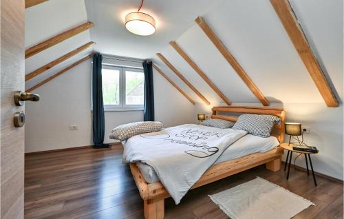 a bedroom with a wooden bed in a room at Stunning Home In Varazdinske Toplice With Kitchenette in Varaždinske Toplice