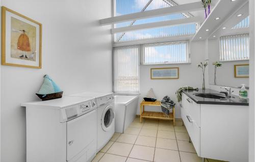 a laundry room with a washing machine and a sink at Holiday Home Næsvej Assens in Assens
