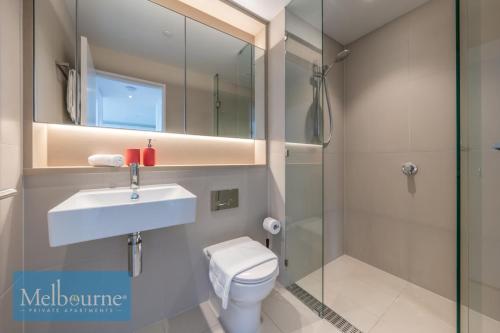 a bathroom with a toilet and a sink and a shower at Melbourne Private Apartments - Collins Wharf Waterfront, Docklands in Melbourne