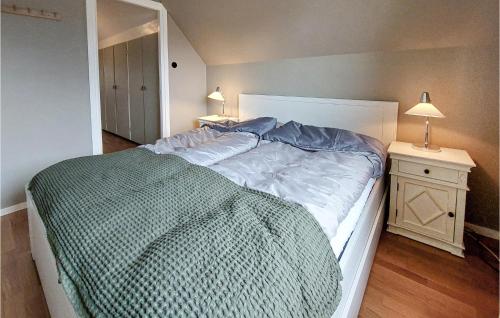a bedroom with a large bed and two night stands at Awesome Home In Viken With Wifi And 2 Bedrooms in Viken