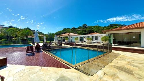 a swimming pool in the middle of a house at Geribá Dream House in Búzios