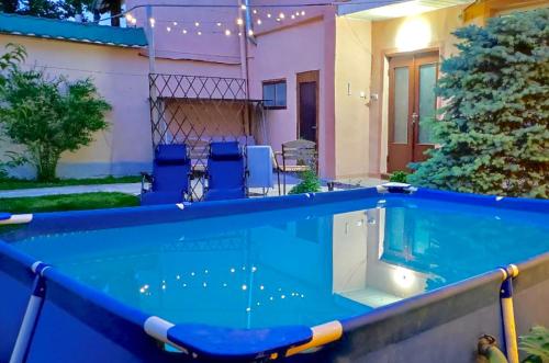 a swimming pool in front of a house at FRODO in Tashkent