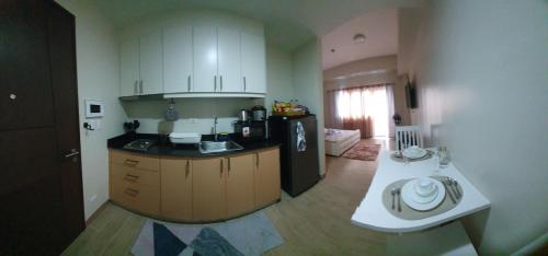 a kitchen with a sink and a counter top at Megaworld-Manduriao, Iloilo Lafayette in Iloilo City