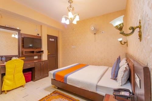 a bedroom with a bed and a desk and a television at Hotel Royal Kathmandu in Kathmandu