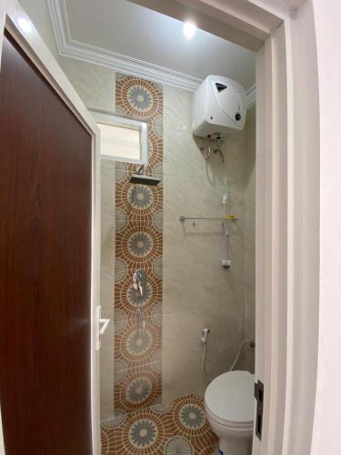 a bathroom with a toilet and a shower at Villa Permata Panderman 20 in Batu