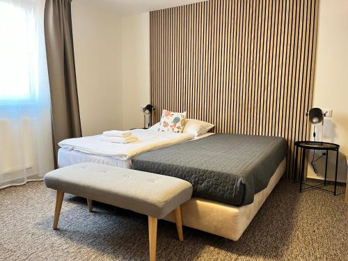 a hotel room with two beds and a window at Penzion U Halmů in Hustopeče