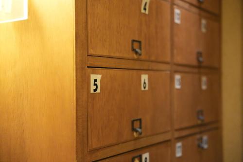 a row of lockers with the number on them at Guest House Tokyo Samurai in Tokyo