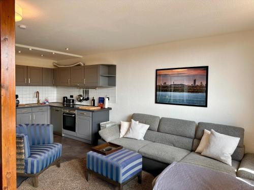 a living room with a couch and a kitchen at Geschmackvolle Ferienwohnung in Markkleeberg in Markkleeberg