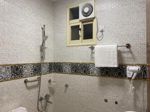 een badkamer met een douche en een raam bij ABHASKY in Abha