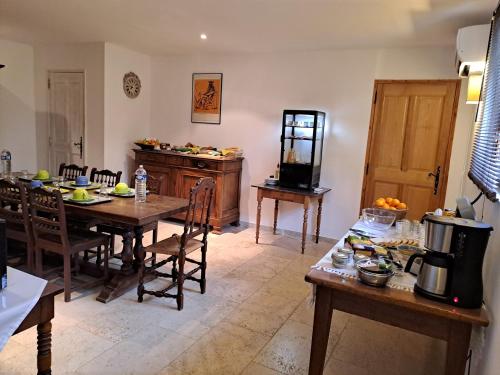 a kitchen with a table and chairs in a room at La Bastide de l'Oliveraie in Le Castellet