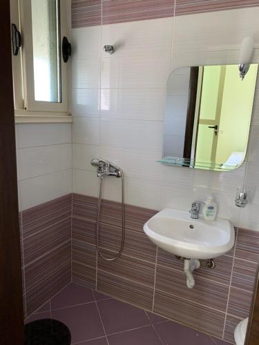 a bathroom with a sink and a shower at Apartament Real Vlore in Vlorë