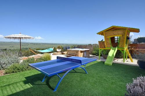 a playground with a picnic table and a slide at וילה אלטה בוטיק - לנפוש בארץ להרגיש בחו"ל in Mishmār Hāyardin