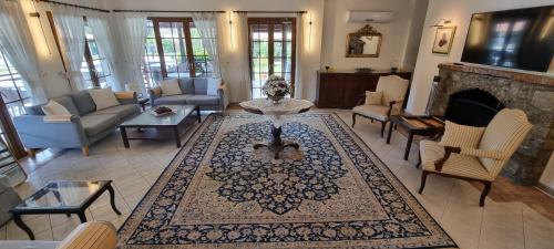 a living room filled with furniture and a fireplace at Efe Hotel Gocek in Göcek