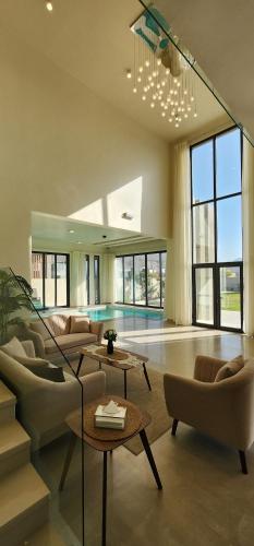a living room with couches and a pool at Noorsila in Ghubrat Ţanūf