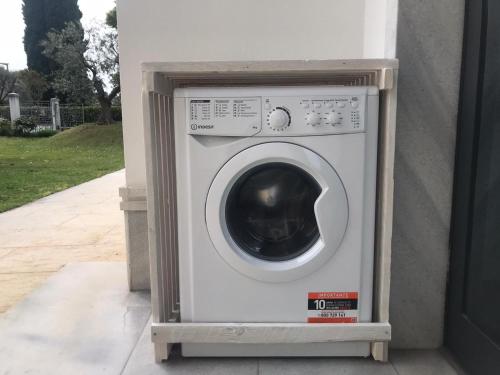 a white washing machine sitting in a building at Villa Sergio in Bardolino