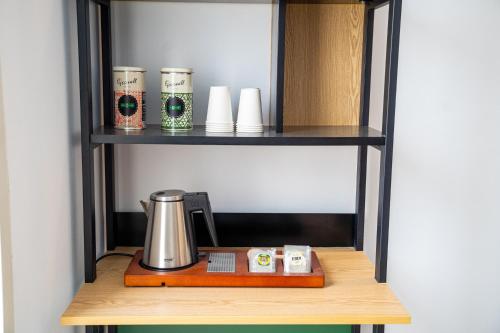 a shelf with a coffee pot and other items on it at Hostal Tarantelo Conil in Conil de la Frontera