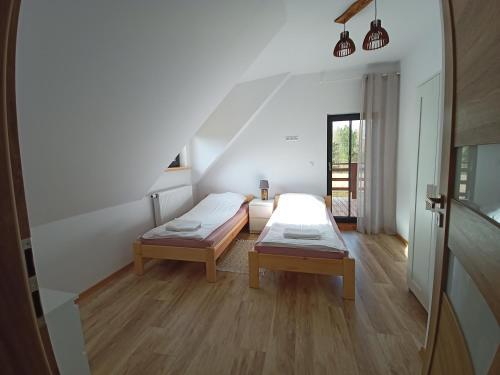 a room with two beds and a staircase in a house at Chillout House Serwy in Serwy