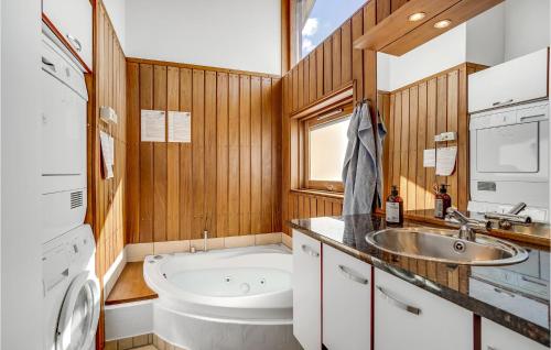 a bathroom with a tub and a sink and a bath tub at Beautiful Home In Sjlund With 2 Bedrooms And Wifi in Hejls