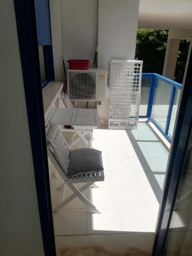 a view of a balcony with a chair and a table at Apartamento confortable en la bahia de Alicante in Alicante