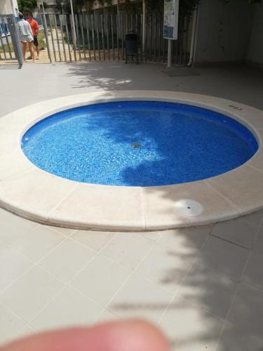 a small blue pool in a building at Apartamento confortable en la bahia de Alicante in Alicante