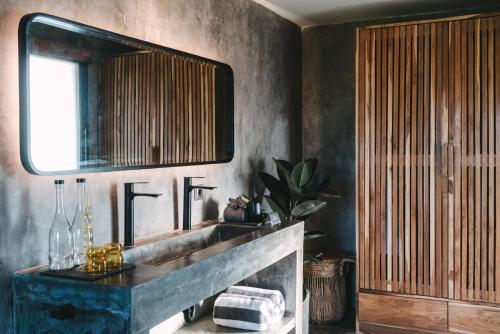 a bathroom with a sink and a mirror at Beach 600M - Designer Villas - Perenenean - Private Pool in Canggu