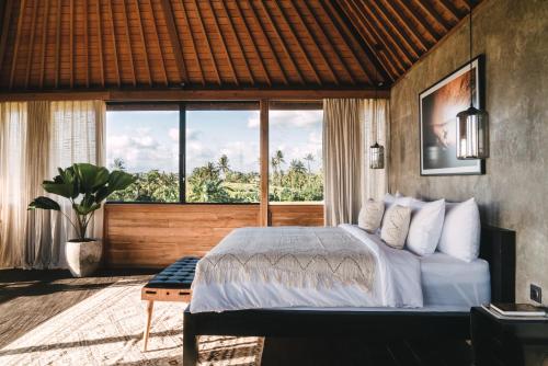 a bedroom with a bed and a large window at Beach 600M - Designer Villas - Perenenean - Private Pool in Canggu