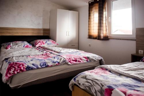 a bedroom with two beds and a window at Apartments Joja in Međugorje