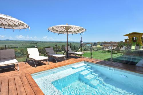a swimming pool with chairs and umbrellas on a deck at THE ALTA GALILEA - 3BRM WITH POOl in Mishmār Hāyardin