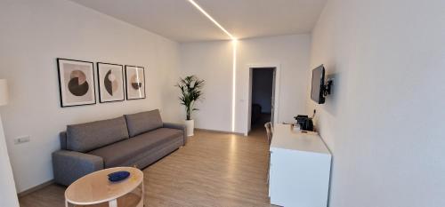 uma sala de estar com um sofá e uma mesa em SARDINIA SUITES & APARTMENTS -Suite in centro- em Santa Teresa Gallura