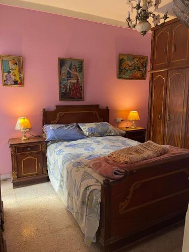 a bedroom with a large bed and two night stands at شقه مفروشه سوبر لوكس بميامى الاسكندريه in Alexandria