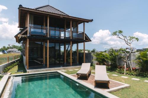 a villa with a swimming pool and a house at Beach 600M - Designer Villas - Perenenean - Private Pool in Canggu