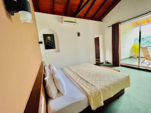 a bedroom with a bed and a large window at The SkyDeck Kandy in Kandy